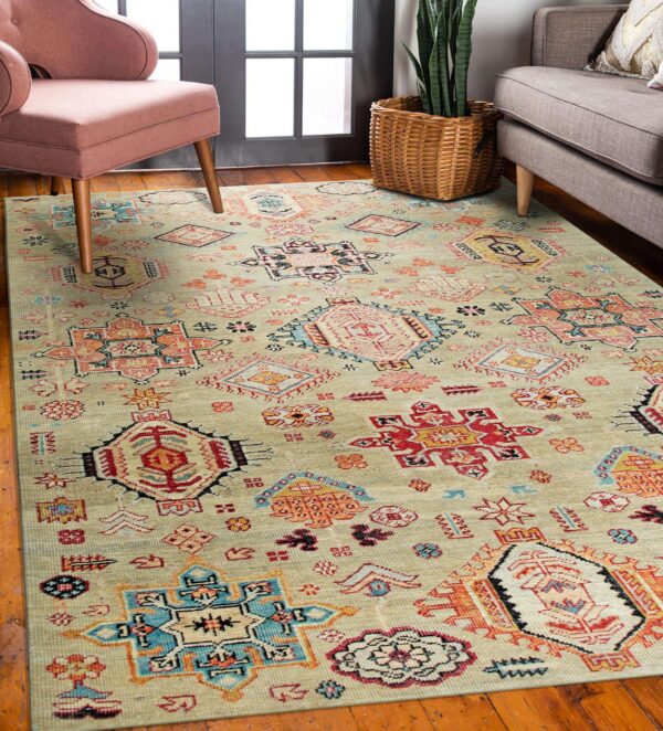 A low-pile pale green rug with red, blue, and coral geometric tribal patterns on a wood floor.