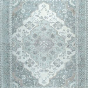 Ornate traditional rug with a central diamond medallion, displaying distressed pale blue, gray, and white tones.