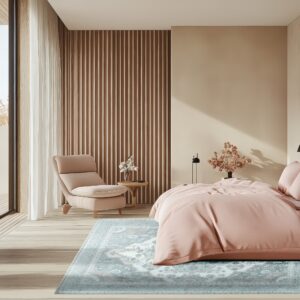 Distressed blue and white traditional rug beneath a pink-covered bed on light wood floors.