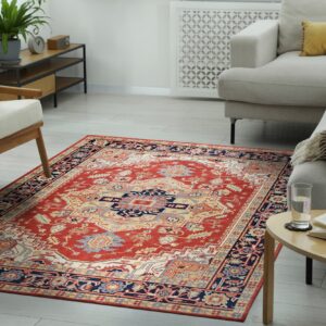 Traditional red, navy, and beige rug with a medallion pattern grounding a bright, neutral living room.
