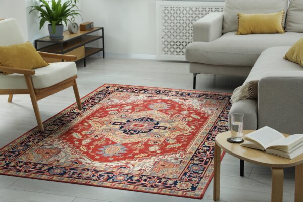 Traditional red, navy, and beige rug with a medallion pattern grounding a bright, neutral living room.