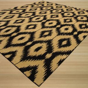 A black and tan rug featuring an abstract ikat diamond pattern rests diagonally on light wood flooring.