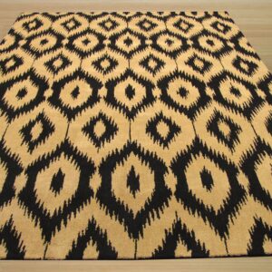 Black and tan medium-pile rug with large ikat diamond pattern resting on light wood floor.