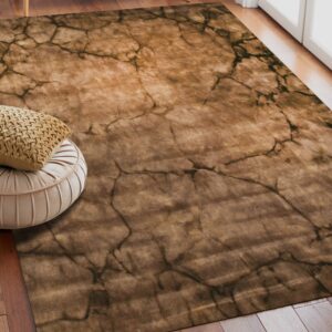 Brown abstract rug featuring dark cracked lines is laid on wood planks next to a light pleated ottoman.