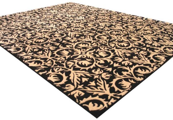 Ornate black and beige rug with a carved, high-low scrolling floral pattern, isolated on white.