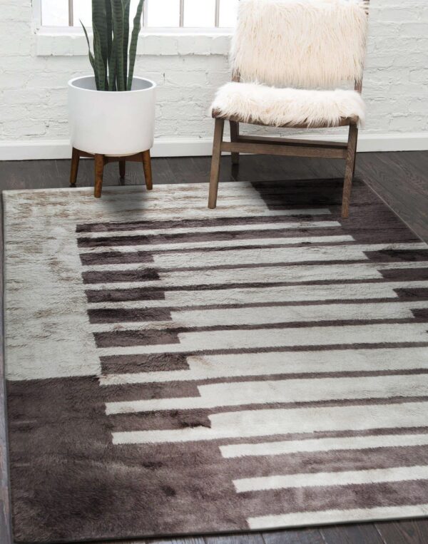 High-pile rug in dark taupe and off-white with a keyboard pattern on dark wood floors.