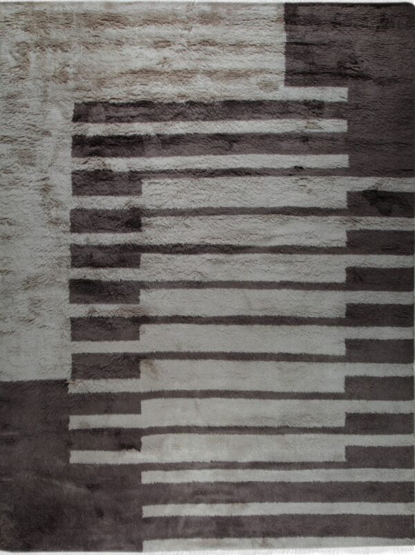 A high-pile rug features an abstract staggered geometric pattern using light grey and dark brown colors.