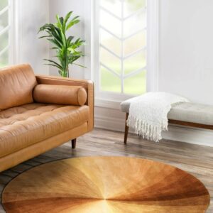 Brown and gold radial gradient round rug in a bright room with a camel leather sofa.