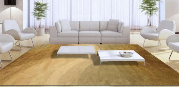 Abstract gold and brown striped rug under two white tables, framed by a white sectional and chairs.