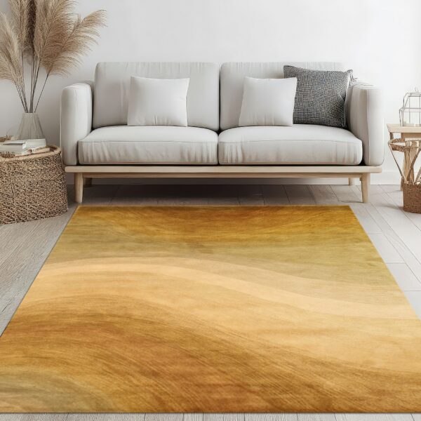 Smooth gold and amber rug with a subtle flowing abstract pattern sits beneath a white sofa.