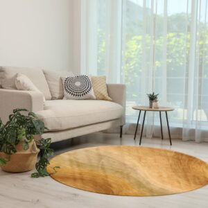 Round rug with wavy yellow and gold stripes complementing a cream sofa on light wood floors.