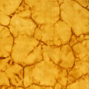 The rug features a golden yellow and deep brown abstract cracked stone pattern.