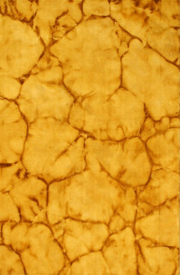 The rug features a golden yellow and deep brown abstract cracked stone pattern.
