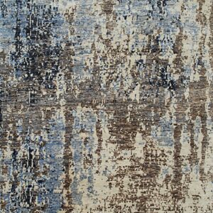 Abstract area rug with an overall distressed pattern in shades of blue, beige, brown, and gray.