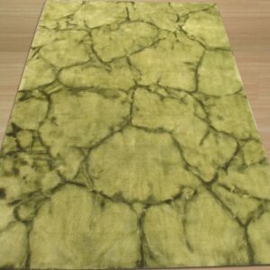 Chartreuse area rug with an irregular dark green crackle design covers a wood floor.
