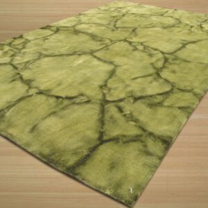 A rectangular green rug features a dark crackle pattern, placed on light wood flooring.