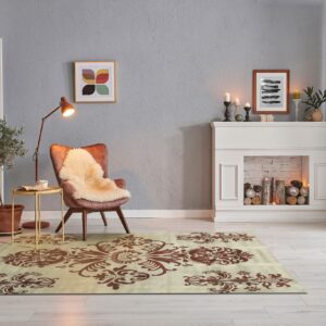 A beige rug with large brown damask patterns anchors a reading nook with an armchair and fireplace.