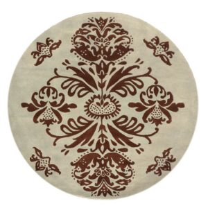 A round low-pile rug with a brown symmetrical floral damask pattern on a cream background.