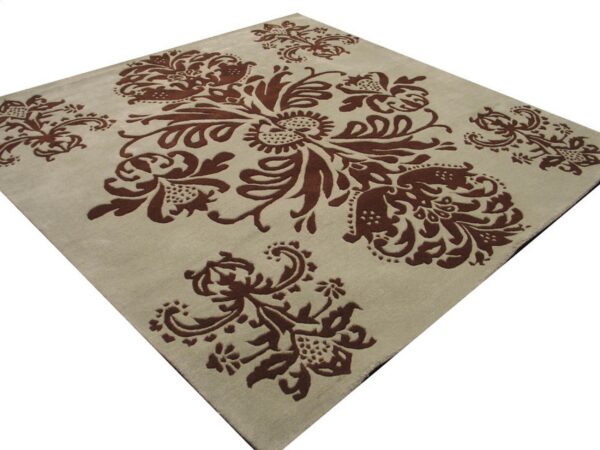 Square beige and brown rug featuring a large carved floral pattern with high-low pile.