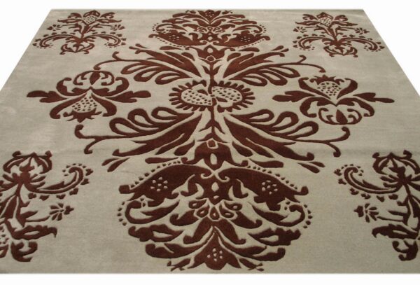 A light gray rug features a large, dark brown, sculpted floral and damask pattern in the center.