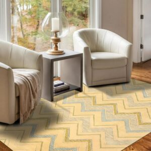 Yellow and pale blue zigzag rug grounds a seating area with two cream chairs and a gray side table.