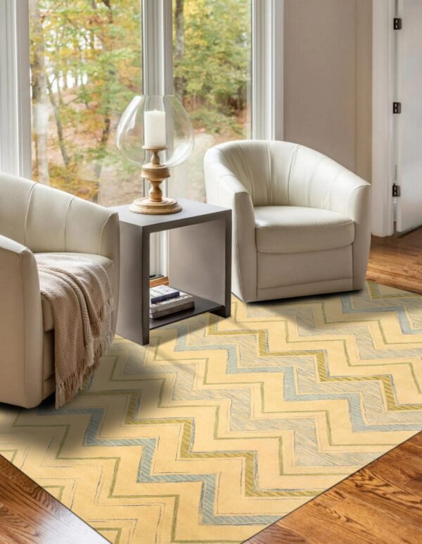 Yellow and pale blue zigzag rug grounds a seating area with two cream chairs and a gray side table.