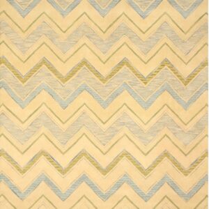A cream rug featuring a large chevron pattern in textured light blue and olive green.