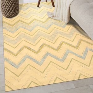 Pale yellow rug with blue and green sketchy zigzag stripes on light wood floors.