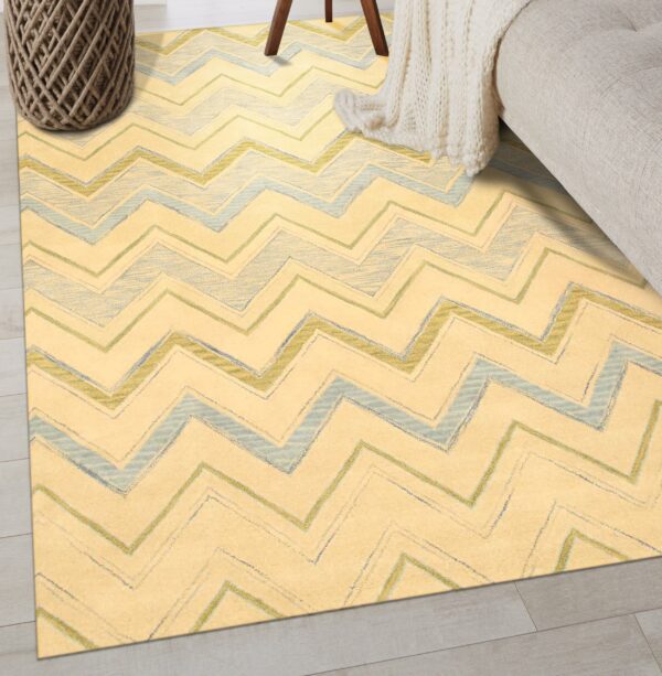 Pale yellow rug with blue and green sketchy zigzag stripes on light wood floors.