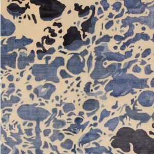Abstract low-pile rug featuring ivory, light blue, and dark navy organic splotches.