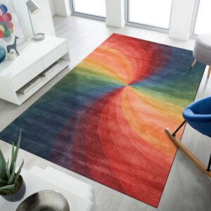 Multi-colored rug with a vibrant swirling pattern lays on light grey flooring in a bright modern room.