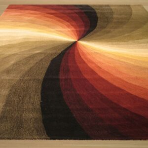 Warm-toned abstract rug featuring a vibrant spiral of red, orange, brown, black, and cream on a wood floor.