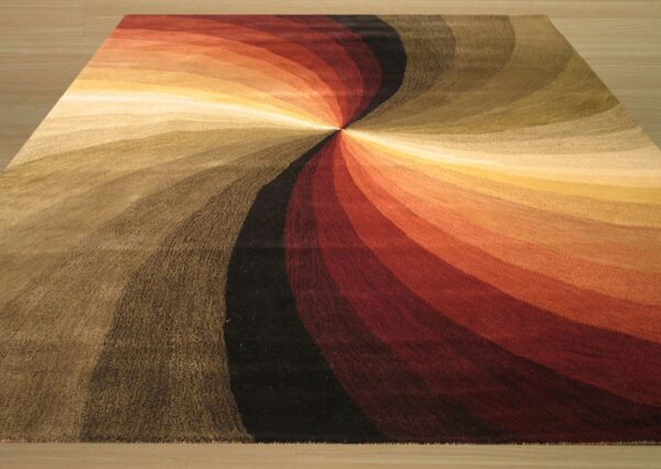 Warm-toned abstract rug featuring a vibrant spiral of red, orange, brown, black, and cream on a wood floor.