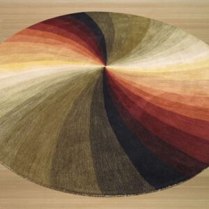 Round rug with a radiating, multi-color swirl pattern in warm earthy tones on light wood flooring.