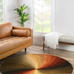 Round low-pile rug with concentric rust, gold, and dark brown swirls in a sunlit living space.