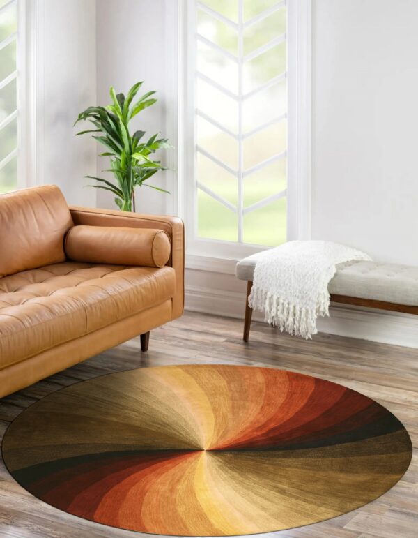 Round low-pile rug with concentric rust, gold, and dark brown swirls in a sunlit living space.
