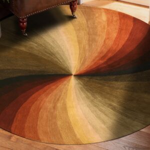This circular rug displays a radial gradient design in brown, olive, gold, and orange tones on wood floor.