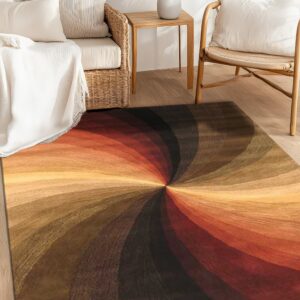 Rug featuring a dramatic spiral pattern in shades of rust, gold, and dark brown on wood flooring.