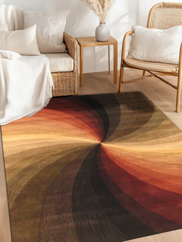 Rug featuring a dramatic spiral pattern in shades of rust, gold, and dark brown on wood flooring.