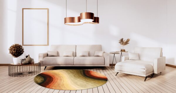Oval rug with wavy bands of orange, yellow, and green colors on light wood floors.
