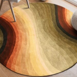 Round, textured rug with wavy orange, yellow, and olive stripes on light wood flooring.