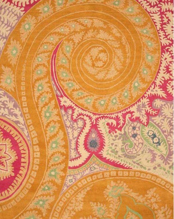 Highly detailed rug pattern featuring a large gold spiral surrounded by magenta, pale green, and cream floral designs.
