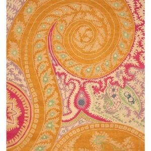 A colorful rug with dense paisley and floral designs in orange, bright pink, cream, and green.