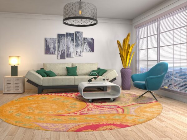 A vibrant orange, pink, and green circular rug grounds a modern living room with a sofa and turquoise chair.