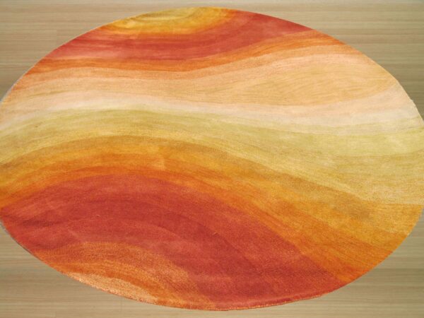 Circular rug with wavy abstract bands of red, orange, and golden yellow colors on light wood flooring.