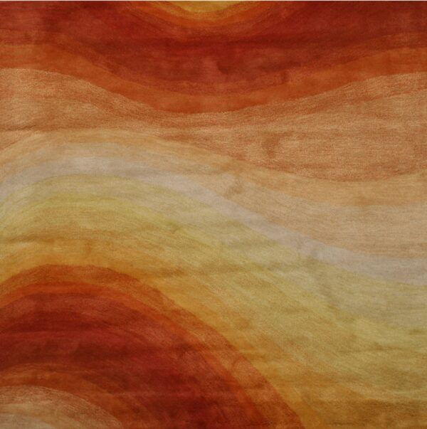 Plush rug detail displaying abstract, curved bands in shades of rust, orange, goldenrod, and cream.