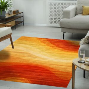 The bright orange and yellow abstract rug lies on light wood floors in a sunny living room.