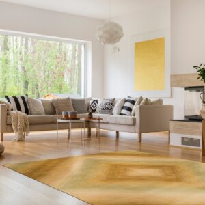 A low-pile area rug featuring yellow and olive green gradient squares brightens a modern living room.
