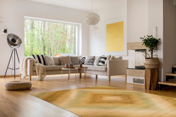 A low-pile area rug featuring yellow and olive green gradient squares brightens a modern living room.