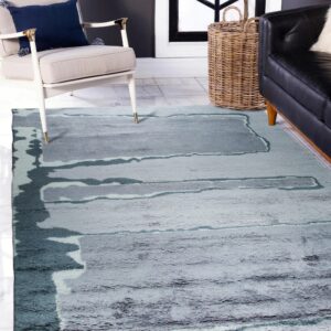 Abstract high-pile rug in gray and teal colors styled with a white armchair and black leather sofa.